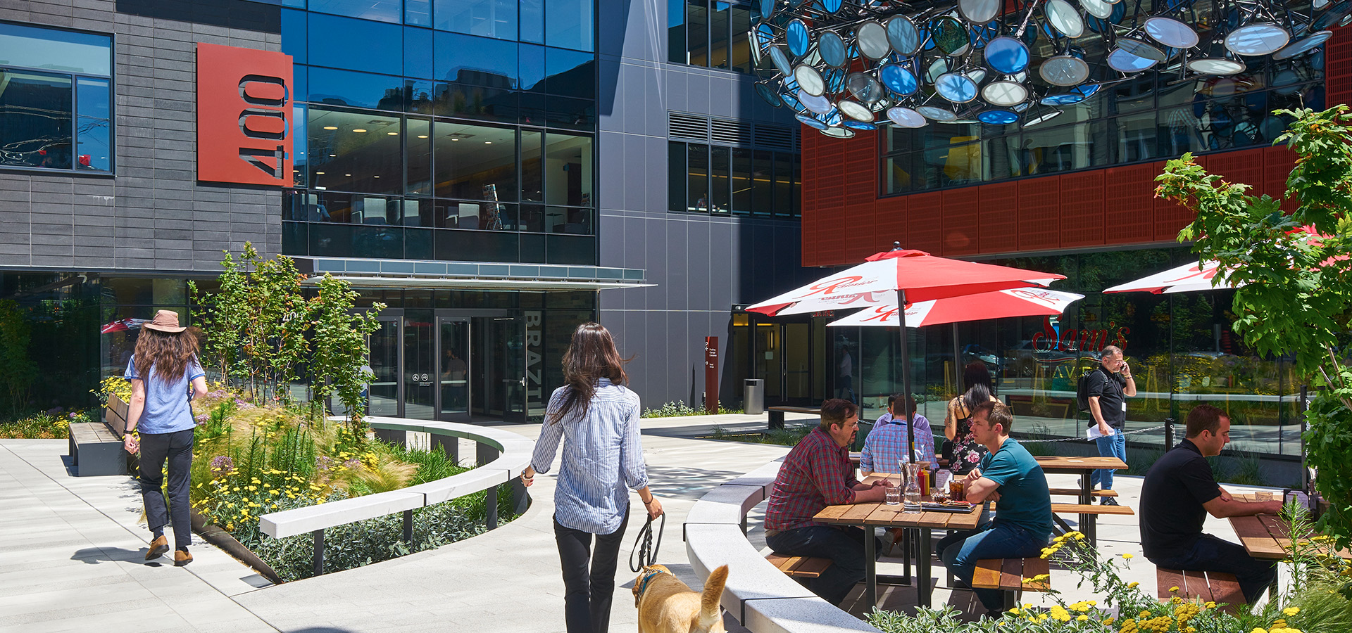 people at table and person walking dog