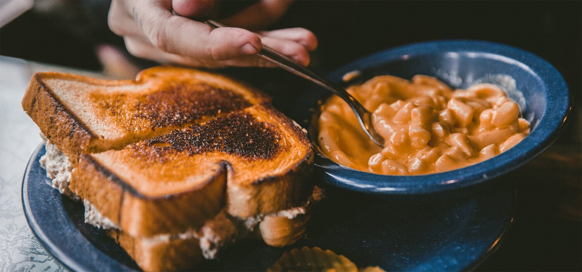 closeup of hand, sandwich and soup