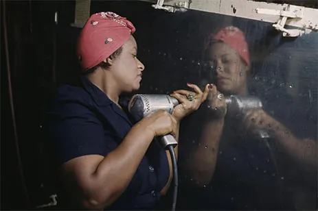 black woman using riveting tool