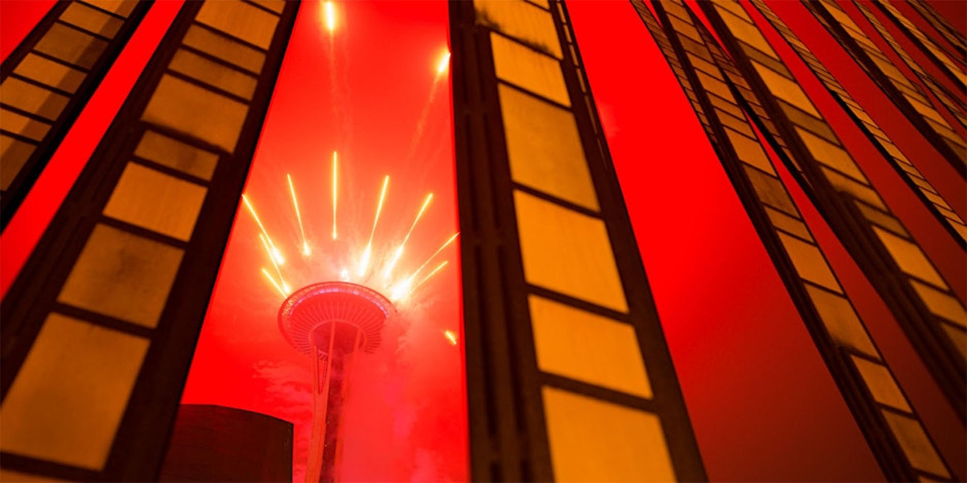red image of space needle and buildings
