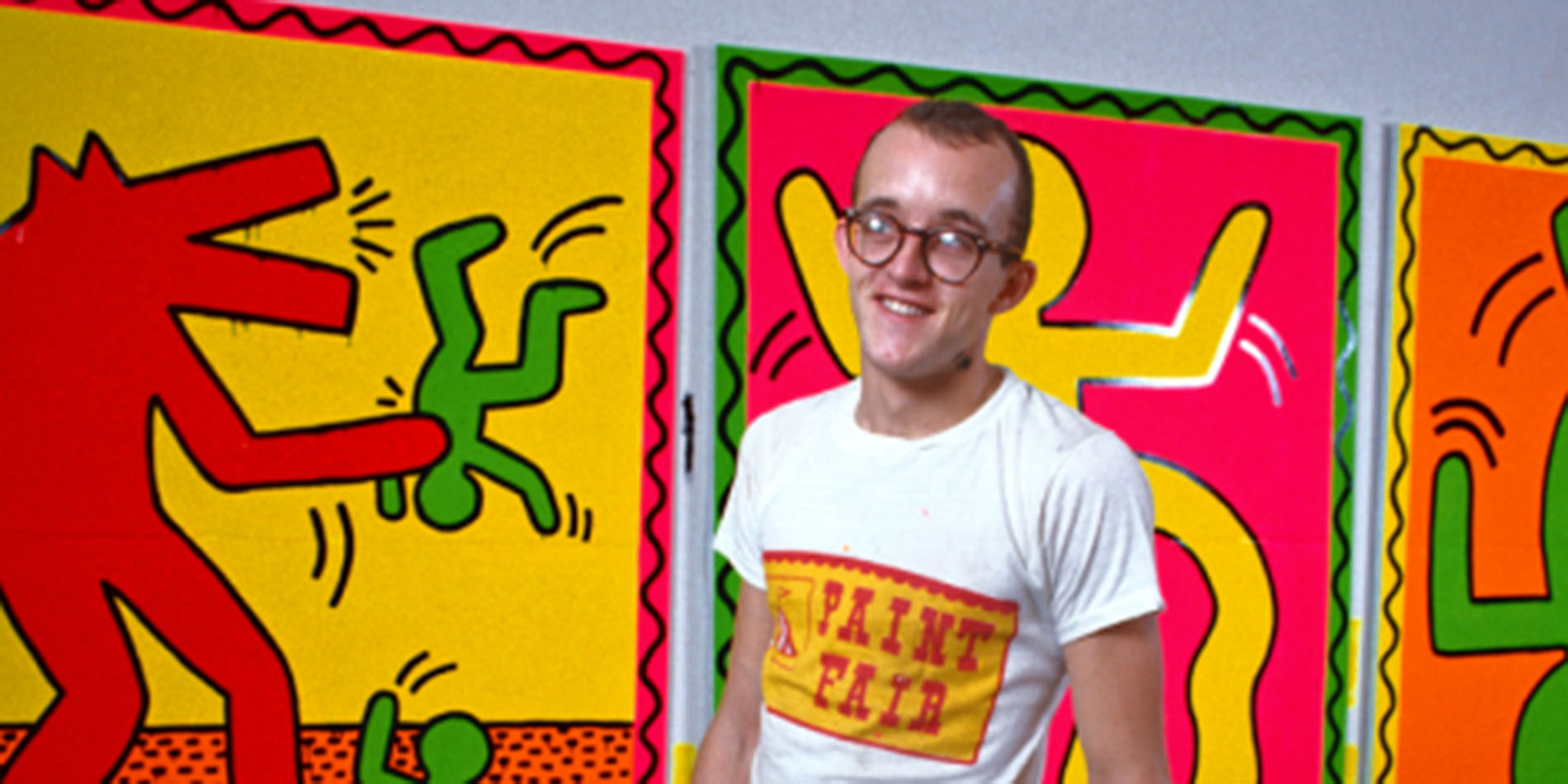 keith haring in front of artwork