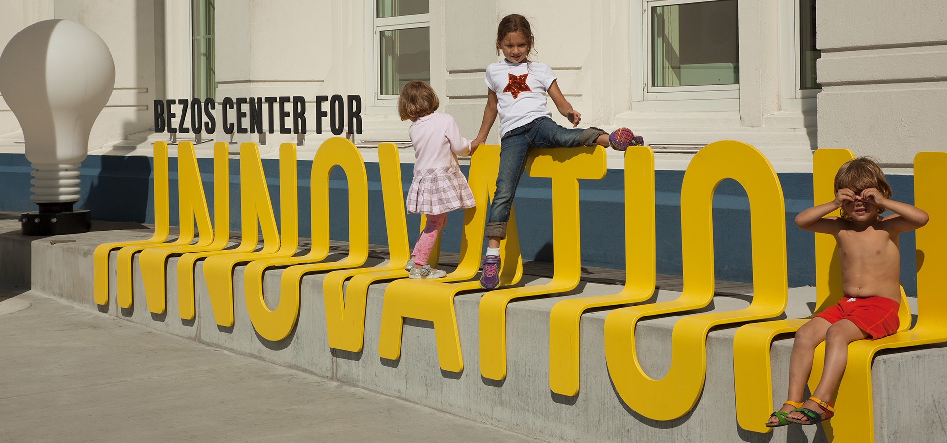 children playing on innovation sign