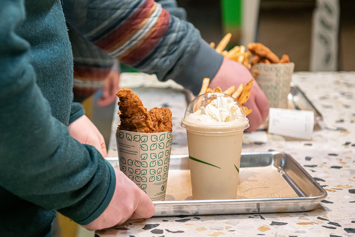 close up of fries, burgers, chicken tenders, drinks