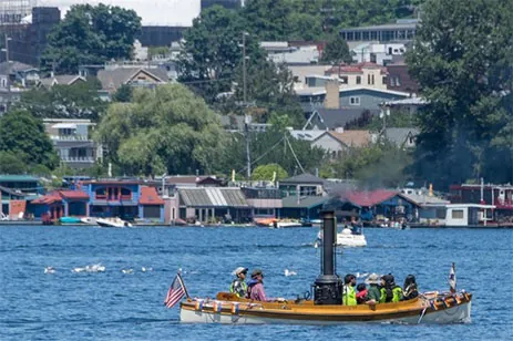 people in boat on lake union