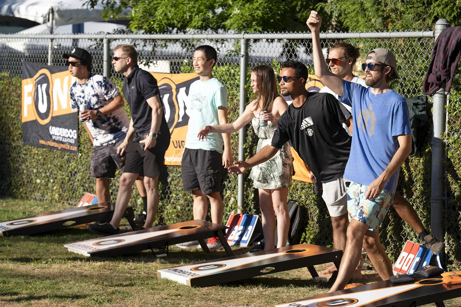 group of people playing cornhole