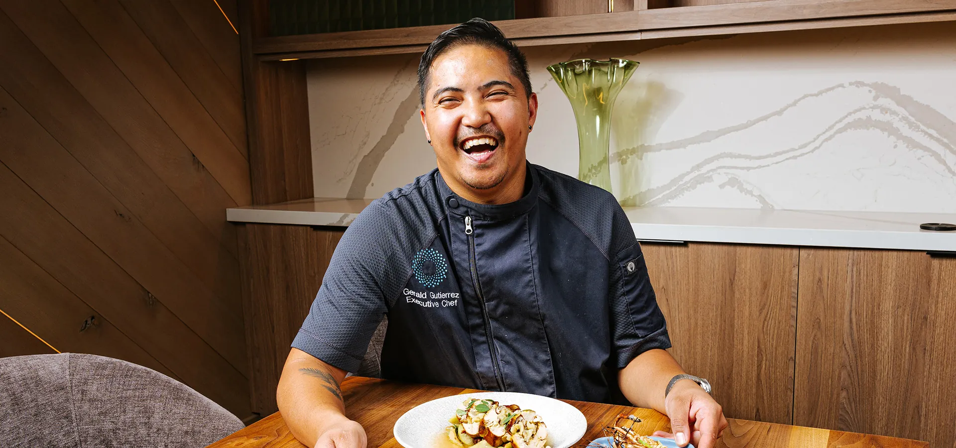 chef smiling with plates of food