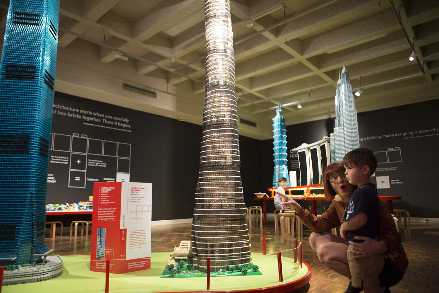 two people looking at lego tower