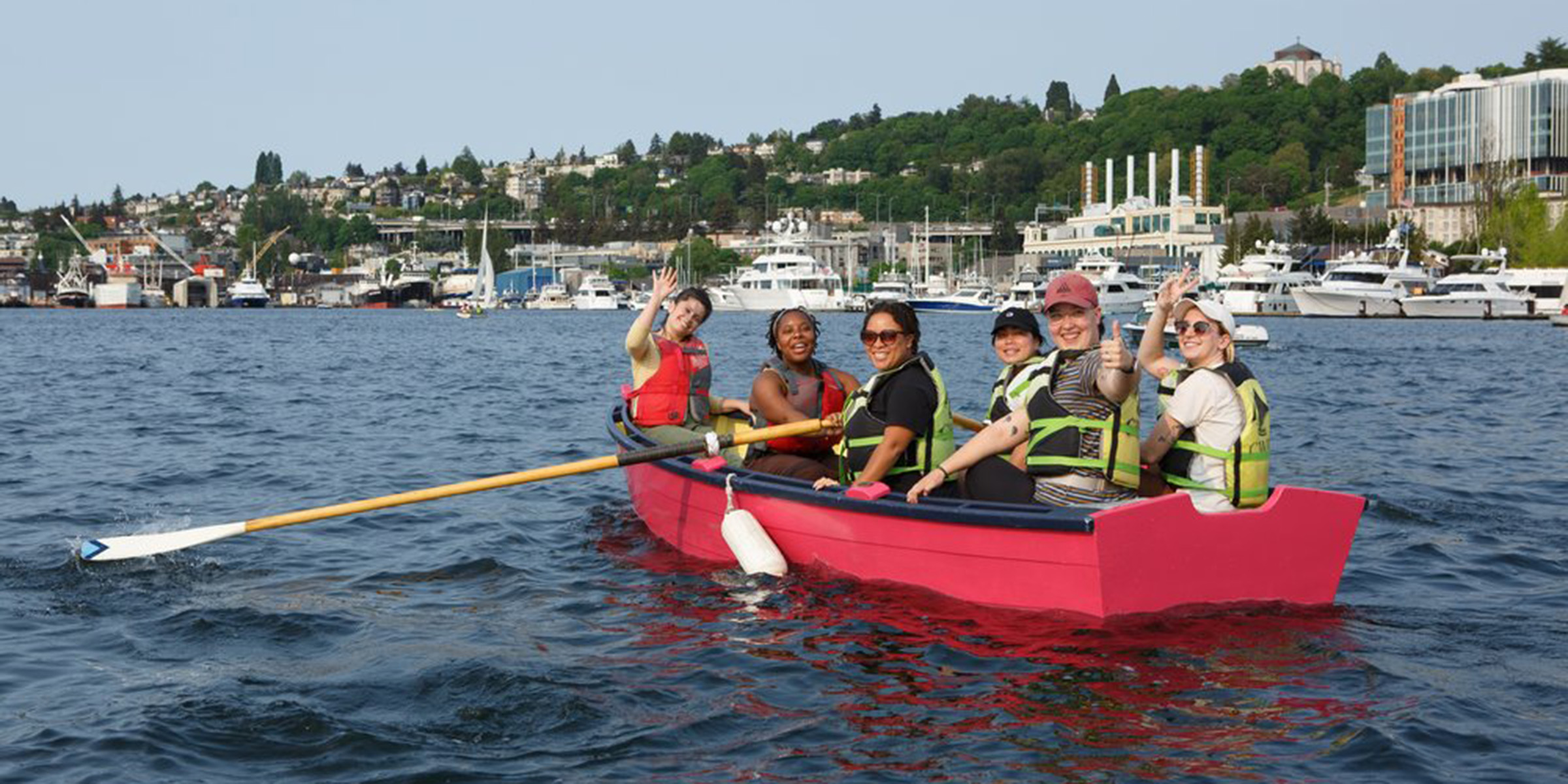 women in rowboat on water