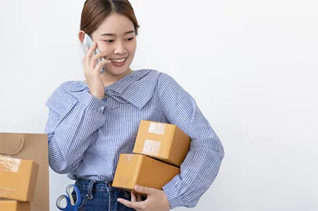 stock photo of women with phone and boxes